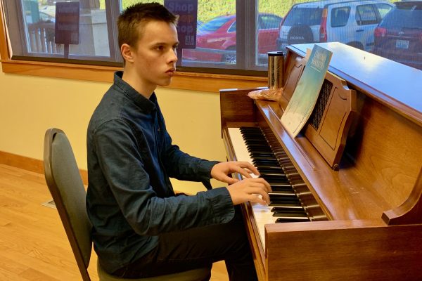Enrichment Scholarship winner plays piano at Yule Boutique