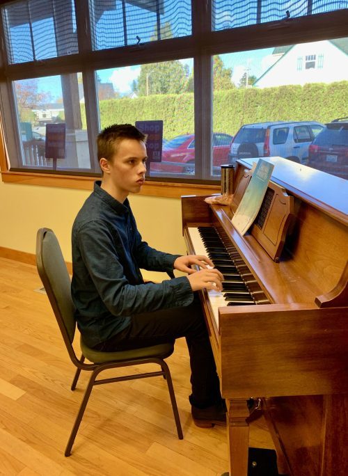 Enrichment Scholarship winner plays piano at Yule Boutique