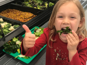 girls giving thumbs up to organic lettuce