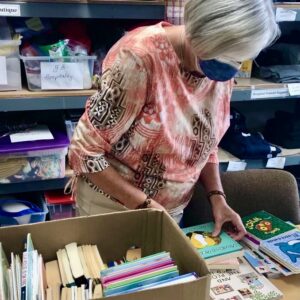 ALB volunteer sorts books