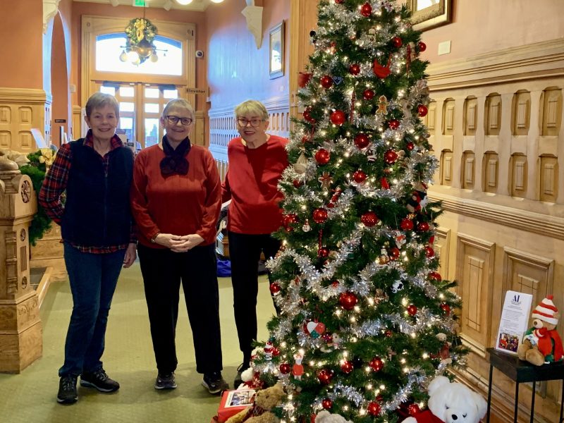 Assistance League members with their newly decorated tree