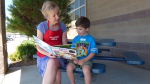 Member reading to child outside of our Philanthropic Center