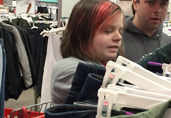 Teen shopping for jeans at a Teen Retail event