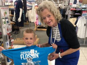 Member helping a child at an Operation School Bell event