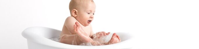 child in bath splashing water