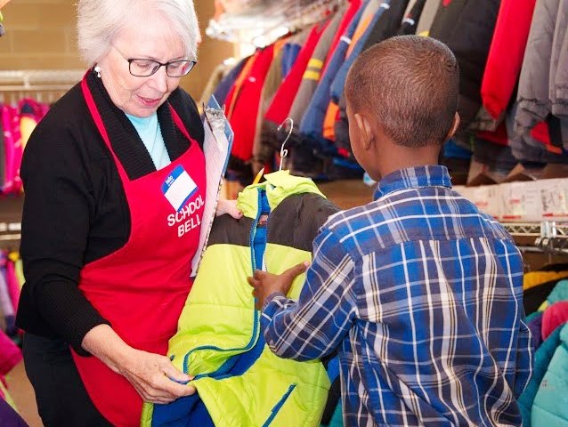 Member showing jacket to child