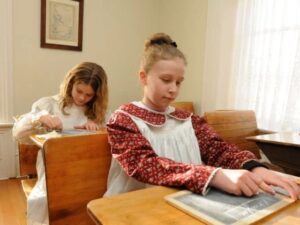 Children in School Room 640x480 Children dressed in period clothing writing on chalkboards in the schoolroom at the Bown House