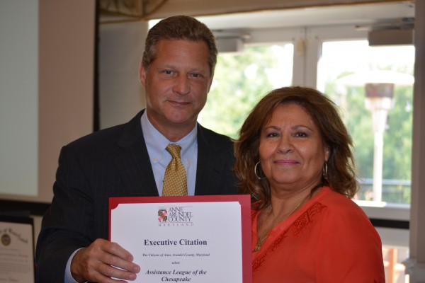 Anne Arundel County Executive Steve Schuh presents a certificate of appreciation to Assistance League of the Chesapeake President Valerie Rees