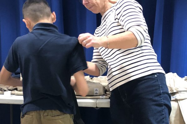 Kids In Need being measured for new uniforms