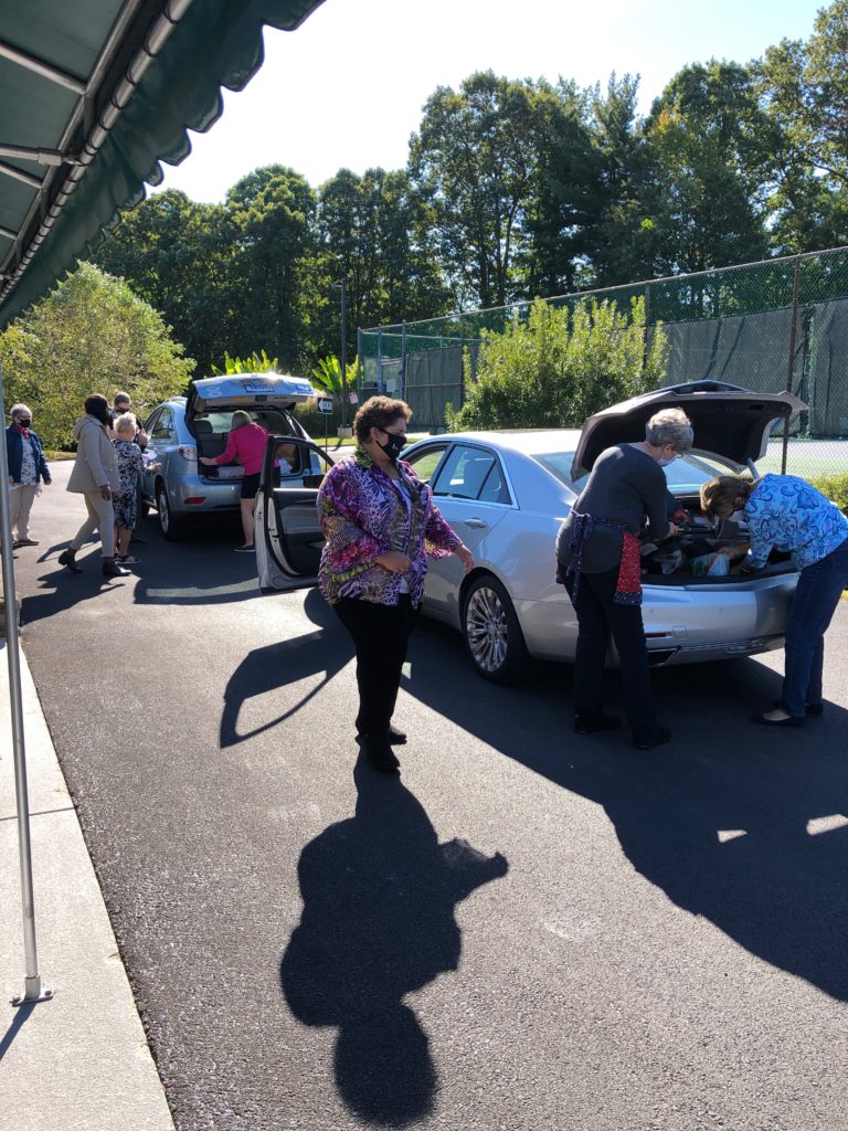 Members drive up to the Stork's Nest Baby Shower to donate items.