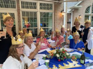 Anniversary luncheon attendees wearing crowns