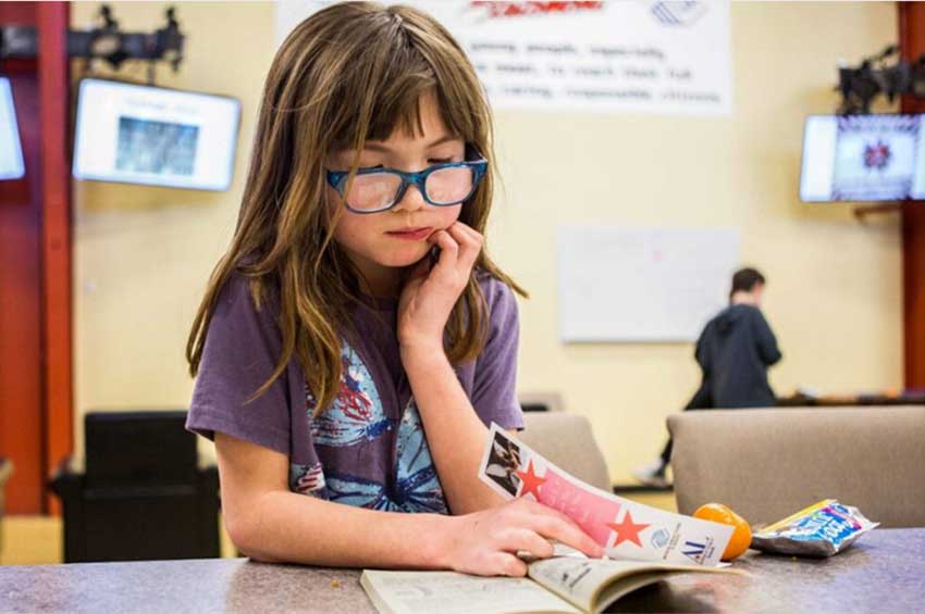 home_photo_2 Girl in school reading
