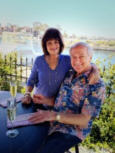 Vickie and Jim Sullos sitting on patio_300Wx400H 2021-04-02