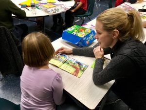 20180101 RE Blond woman working with child in pink top