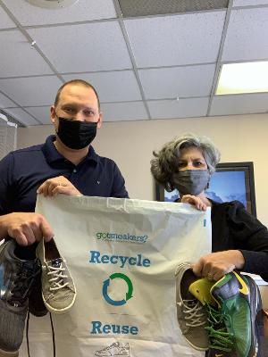 Members of the Family Chiropractic Center of Oakton holding a Got Sneakers campaign bag