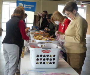 Volunteers from ALNV and Dominion pack food from various bins