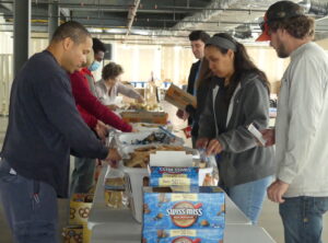 Volunteers standing over a packing line during the WFFK event