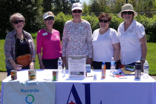 Five ALNV members stand behind a table for a photo at the ALNV shred event
