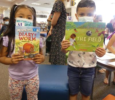 Children holding book as part of the Readers and Leaders ALNV program