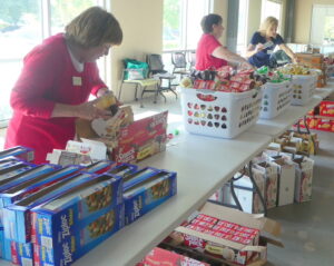 A shot of volunteers preparing packages for the WFFK program