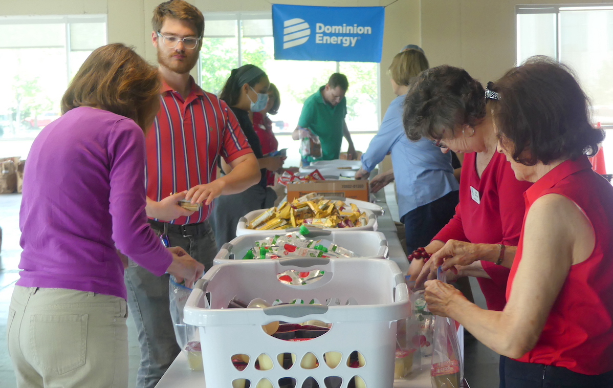 A view of a table of food and volunteers for the WFFK event