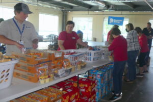 Volunteers from ALNV and Dominion on a packing line for WFFK