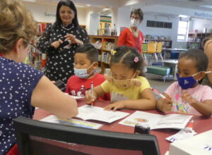 Dr. Jaida with ALNV volunteers and children at the book fair