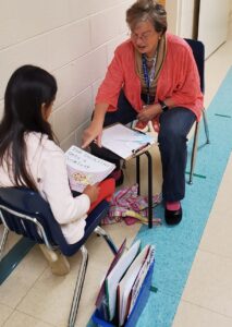 An ALNV volunteer helping to tutor a young student