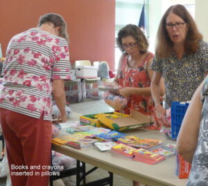 ALNV members helping to prepare, organize, and pack Bedtime Hugs packages for children.