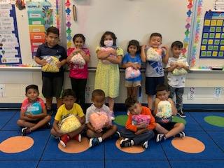 Children hold their bedtime hugs package from ALNV