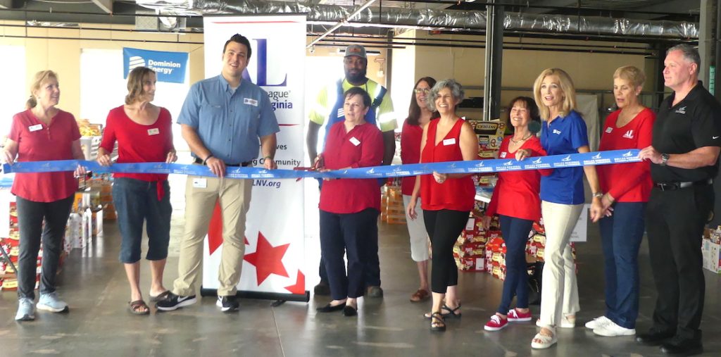 Dominion Energy and ALNV volunteers cut the ribbon at the first post-COVID Weekend Food for Kids packing event