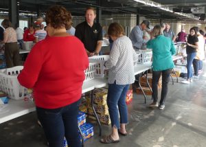 Volunteers pack bags at the Weekend Food for Kids packing event