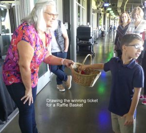 One of the family members of our volunteers assists with the raffle drawing