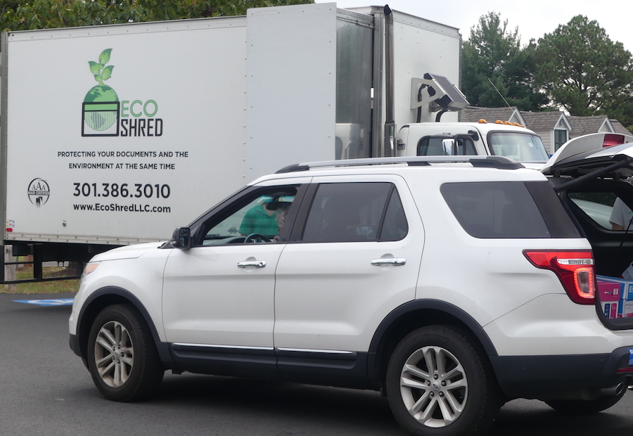 A vehicle is unloaded in front of the shredding truck