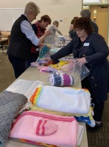 ALNV members packing clothing and blankets for needy families
