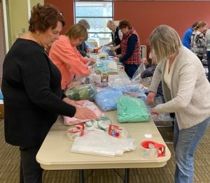 ALNV members assemble various blanket and hygiene packages.