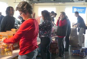 Volunteers pack bags for the Weekend Food for Kids event