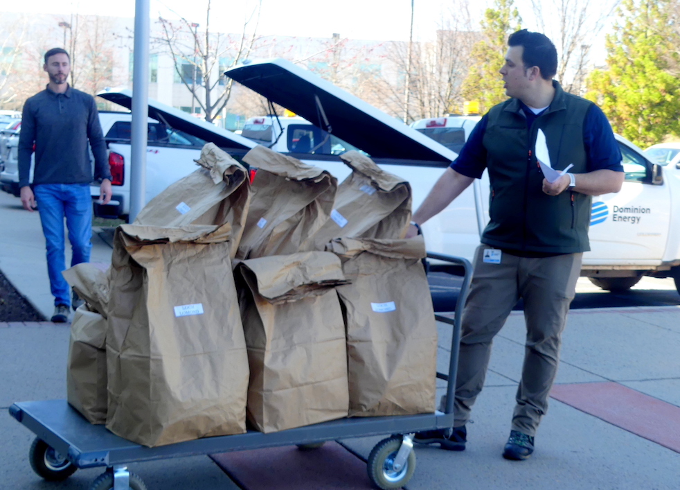 Volunteers helping load food and clothing deliveries