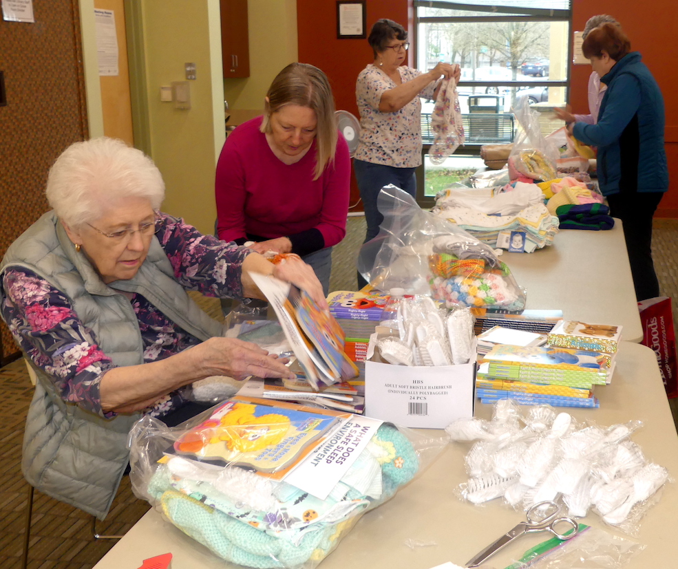 ALNV members sorting through the toiletries and baby-items that will be packaged and donated