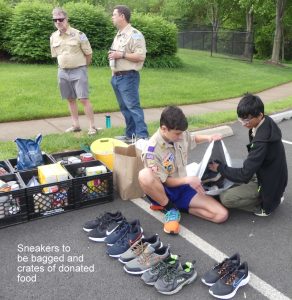 Volunteers from the local Boy Scout troops assist with collection and sorting of sneaker and non-perishable food donations