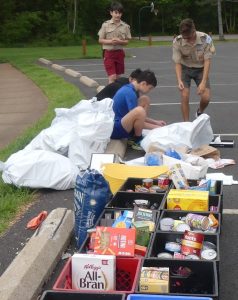 Boy Scouts assist with the assortment of non-perishable goods
