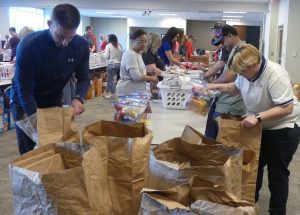 ALNV members packing food and reviewing the items