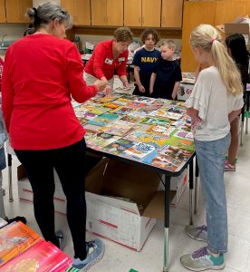 ALNV members work with the children to select new books