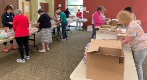 ALNV members sort and label books to be read to various school children in the NOVA area
