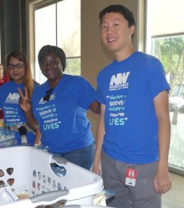 A team of volunteers from Northwest Federal Credit Union pose by some baskets