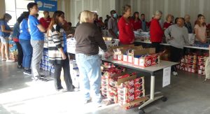 Volunteers look-on as ALNV members discuss the process