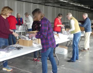 A full assembly line for packing toiletry bags for children in need.