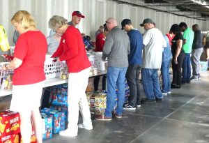 ALNV, Dominion Energy, and Didlake volunteers working together to pack food bags for children in need