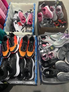 Shoes organized into various boxes for delivery.