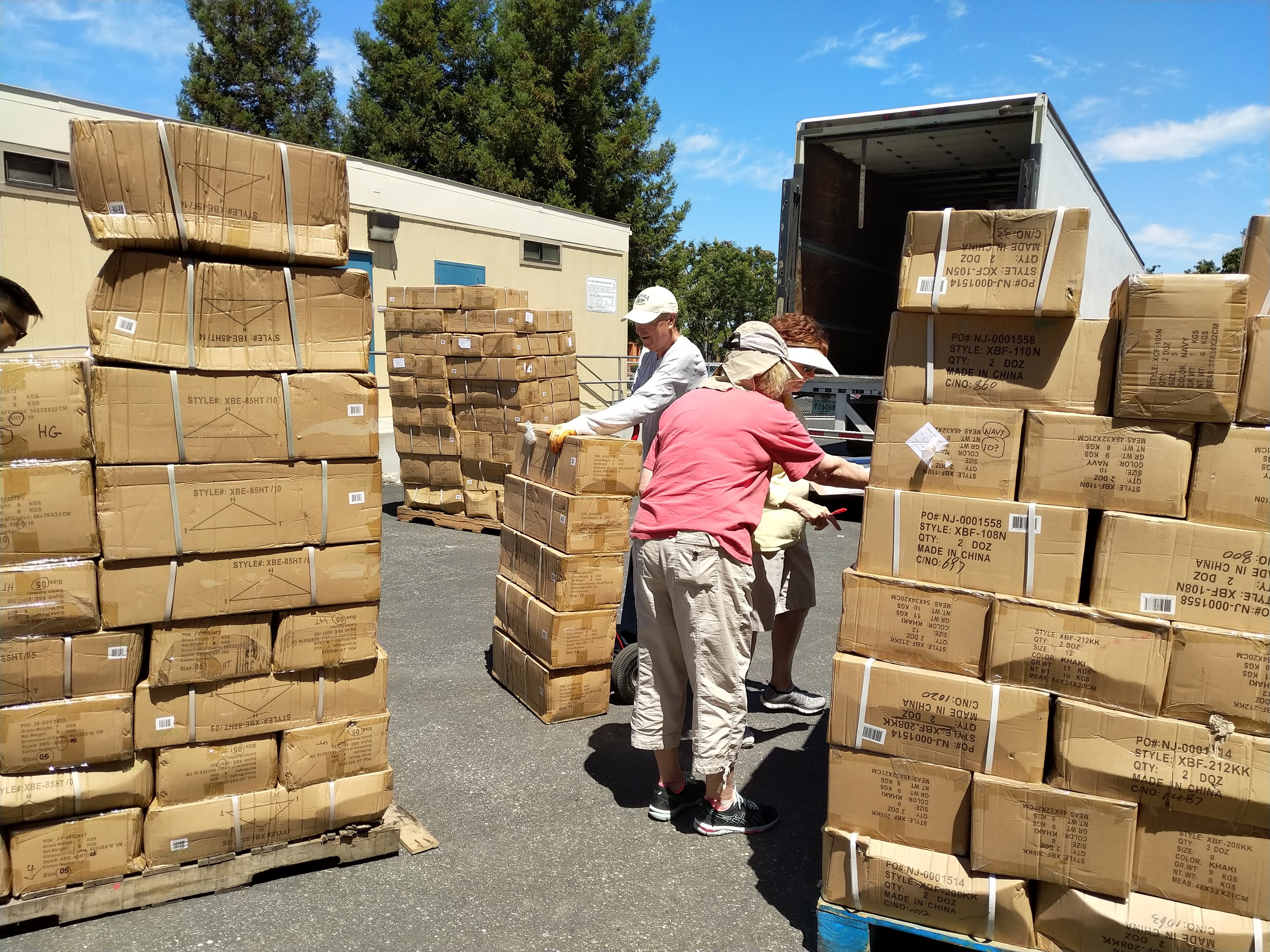 Volunteers unloading boxes of uniforms for OSB